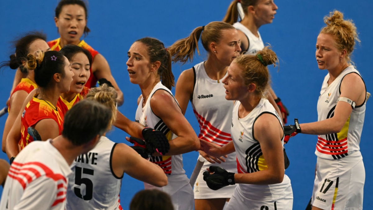 Chinese Field Hockey Player Smokes A Belgian Player With A Midfield Shot After The Final Whistle
