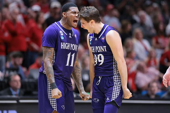 Chase Johnston number 99 and teammate Cam'ron Fletcher celebrating after taking the lead against Wisconsin in the NCAA Tournament at Moda Center in Portland
